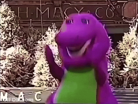 A Purple Dinosaur Is Waving In Front Of A Macy 'S Store GIF