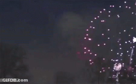 A Purple Fireworks Display In The Night Sky . GIF
