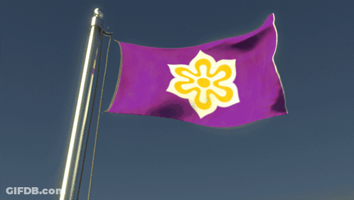 A Purple Flag With A Yellow Flower In The Middle GIF