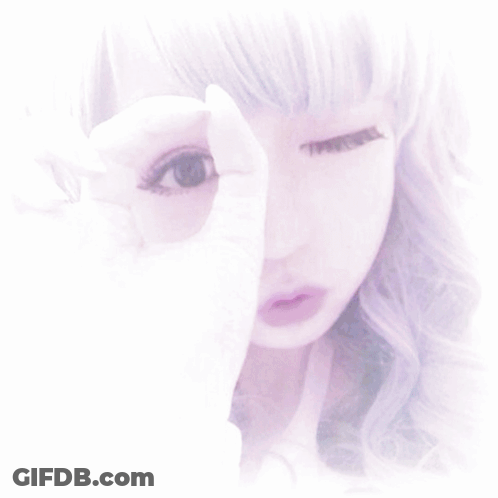 A Purple Hair Clip With A Teddy Bear On It Sits On A Bunch Of Hair GIF