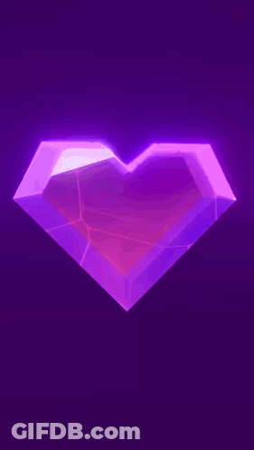 A Purple Heart Is Glowing In The Dark On A Purple Background . GIF