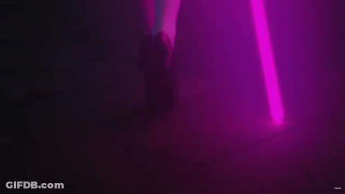 A Purple Light Beam Is Coming Out Of A Purple Object . GIF