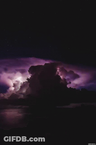 A Purple Lightning Storm Over A Body Of Water With Micheyl At The Bottom GIF