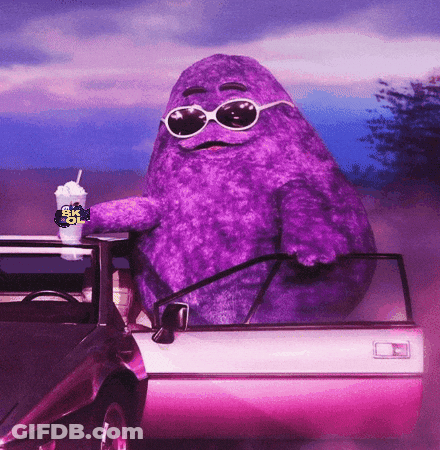 A Purple Mcdonald 'S Character Sitting In A Car GIF