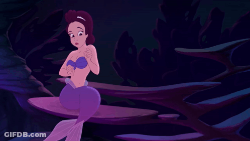 A Purple Mermaid Is Sitting On A Rock In A Dark Cave GIF