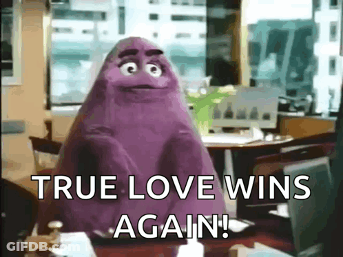 A Purple Monster Is Sitting At A Table With The Words `` True Love Wins Again '' . GIF