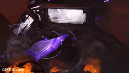 A Purple Object Is Surrounded By Fire And Smoke In A Dark Room GIF