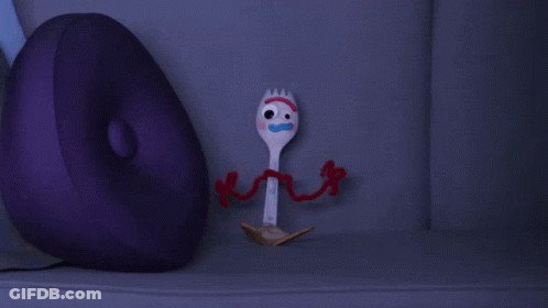 A Purple Pillow Sits Next To A Toy Fork From Toy Story GIF