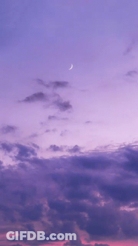 A Purple Sky With A Crescent Moon In The Foreground GIF