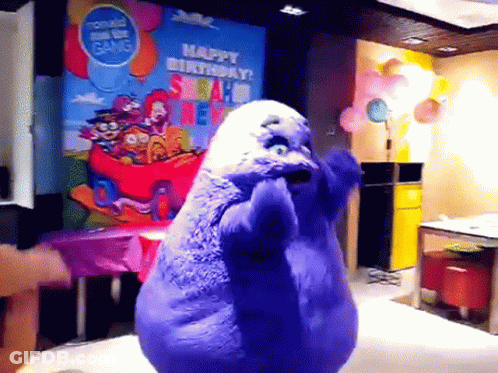A Purple Stuffed Animal Is Dancing In Front Of A Sign That Says Happy Birthday Mcdonald 'S GIF