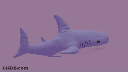 A Purple Stuffed Shark With Its Mouth Open GIF