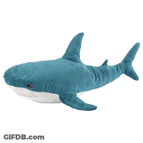 A Purple Stuffed Shark With White Teeth Is Laying On A White Surface GIF