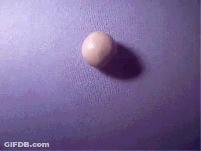 A Purple Surface With A White Ball On It GIF