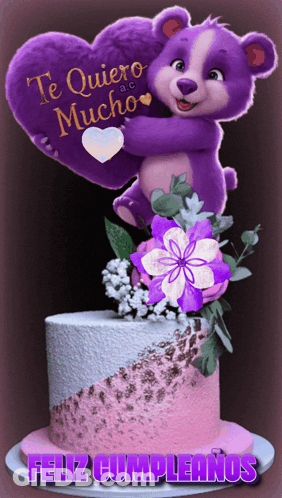 A Purple Teddy Bear Is Holding A Heart On Top Of A Pink And White Cake GIF