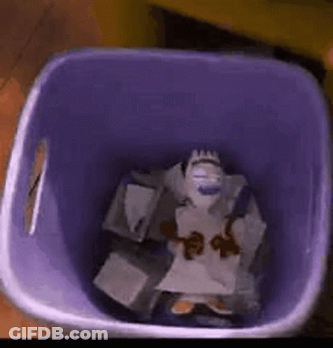 A Purple Trash Can Filled With A Stuffed Animal And Papers . GIF