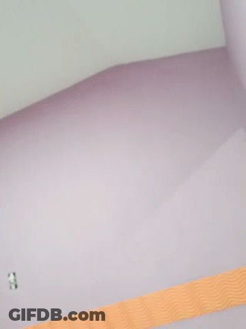 A Purple Wall With An Orange Stripe On The Bottom GIF