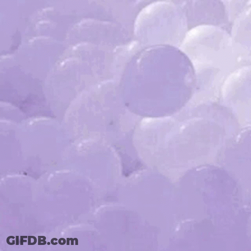 A Purple Wave In The Ocean Is Breaking On The Shore . GIF
