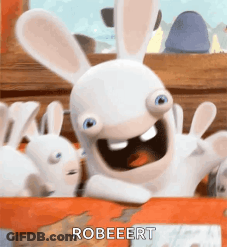 A Rabbit From The Video Game Rabbids Is Sitting On A Table With Its Arms Outstretched . GIF