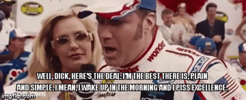 A Race Car Driver Is Talking To A Woman In Front Of A Crowd While Wearing A Goodyear Shirt GIF