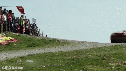 A Race Car Is Driving Down A Dirt Road With The Word Fia On The Bottom Right GIF