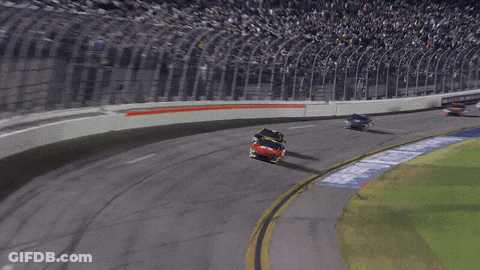 A Race Car Is Going Around A Curve In A Race GIF