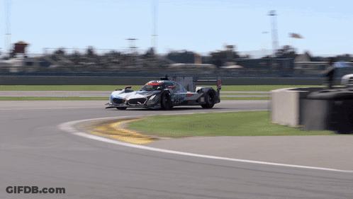 A Race Car Is Going Around A Curve On The Track GIF