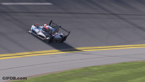 A Race Car Is Going Around A Curve With A Yellow Line On The Side GIF