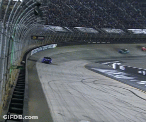 A Race Car Is Going Around A Track With A Sign That Says ' Chase ' GIF