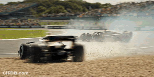 A Race Car That Has Smoke Coming Out Of It 'S Tires GIF