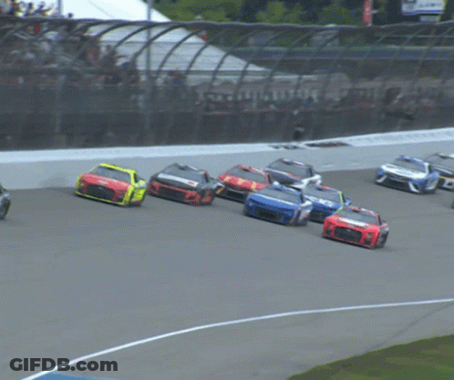 A Race Car With A Blue Stripe On The Side Is Driving Down A Track GIF