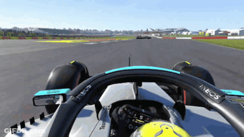 A Race Car With A Steering Wheel That Says Ineos GIF