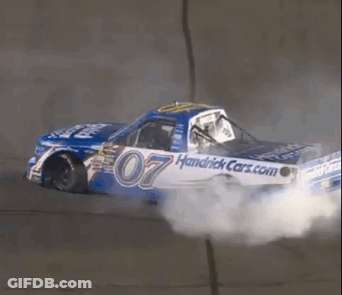 A Race Car With The Number 07 On It Is Driving Down A Track . GIF