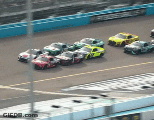 A Race Car With The Number 12 On The Back GIF