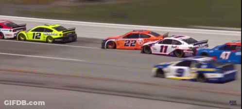 A Race Car With The Number 12 On The Side Of It GIF
