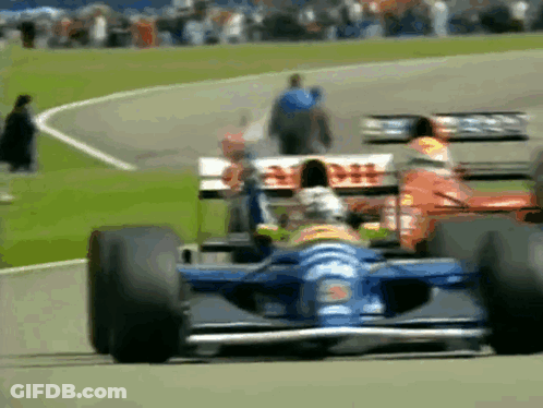 A Race Car With The Word Dhl On The Side Is Driving Down A Track GIF
