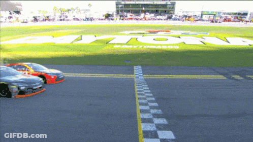 A Race Track With A Large Daytona Logo In The Background GIF