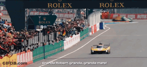 A Race Track With A Sign That Says Rolex In The Background GIF