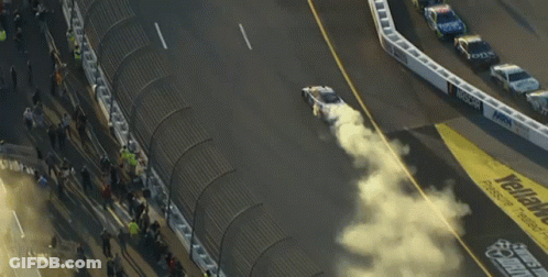 A Race Track With The Word Geico On The Side Of It GIF