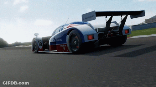 A Racing Car With The Number 18 On It GIF