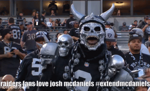 A Raiders Fan Wearing A Skull Mask And Horned Helmet GIF
