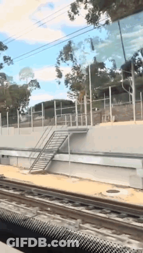 A Railroad Track With A Staircase On The Side GIF