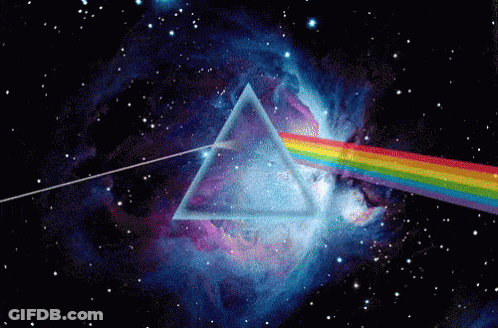 A Rainbow Is Coming Out Of A Triangle In The Middle Of A Galaxy GIF