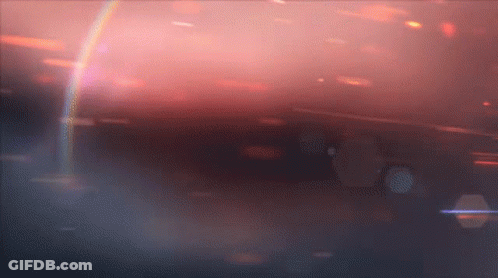 A Rainbow Is Visible In The Middle Of A Dark Background GIF