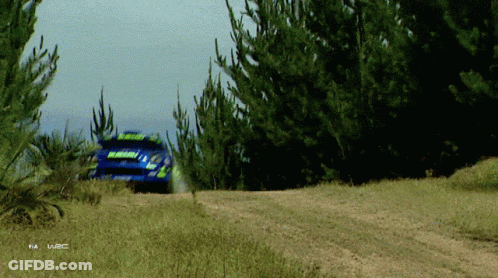 A Rally Car Is Driving Down A Dirt Road With The Word Fia On The Bottom Left GIF