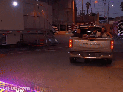 A Ram Truck Is Parked In A Parking Lot At Night GIF