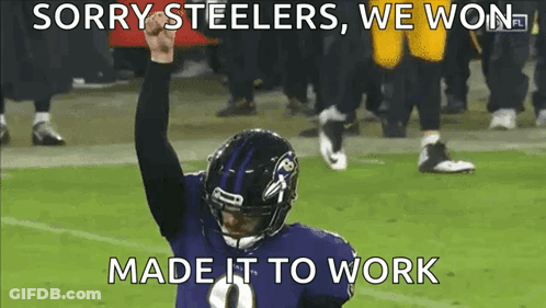 A Ravens Football Player Holds His Fist In The Air GIF