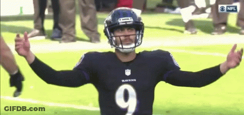 A Ravens Football Player With His Arms Outstretched On The Field GIF