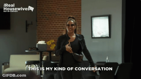 A Real Housewives Advertisement Shows A Woman Standing In A Restaurant GIF