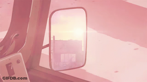 A Rear View Mirror In A Pink Car Shows A Sunset GIF