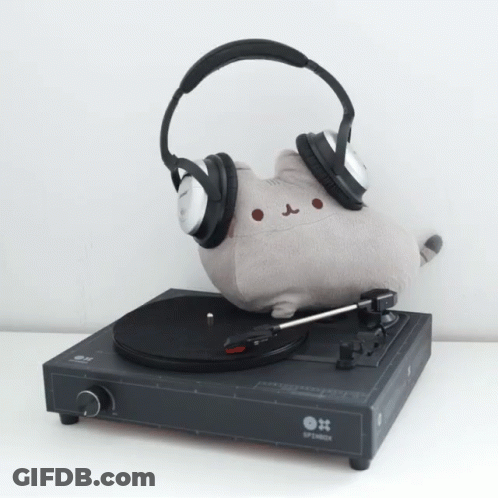 A Record Player With Headphones And A Stuffed Cat On It GIF